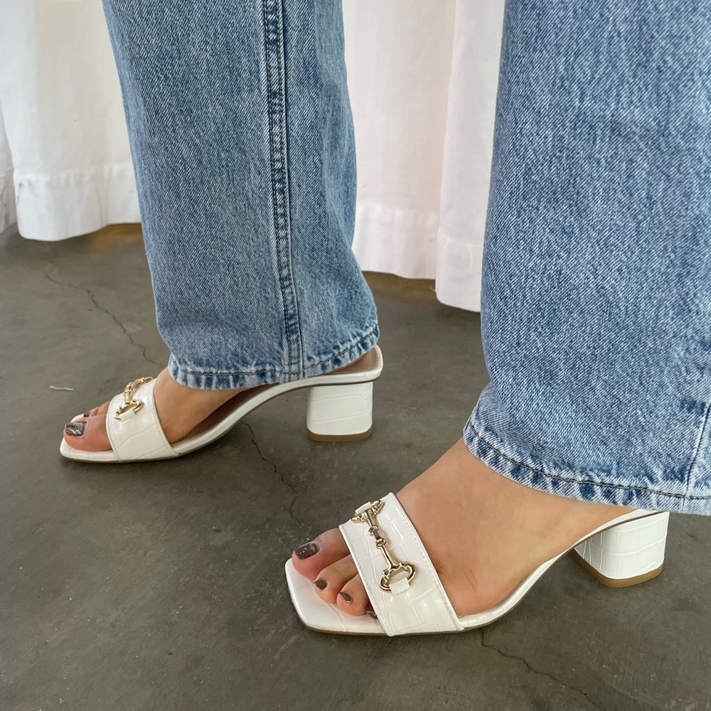 White Steve Madden kitten heels.